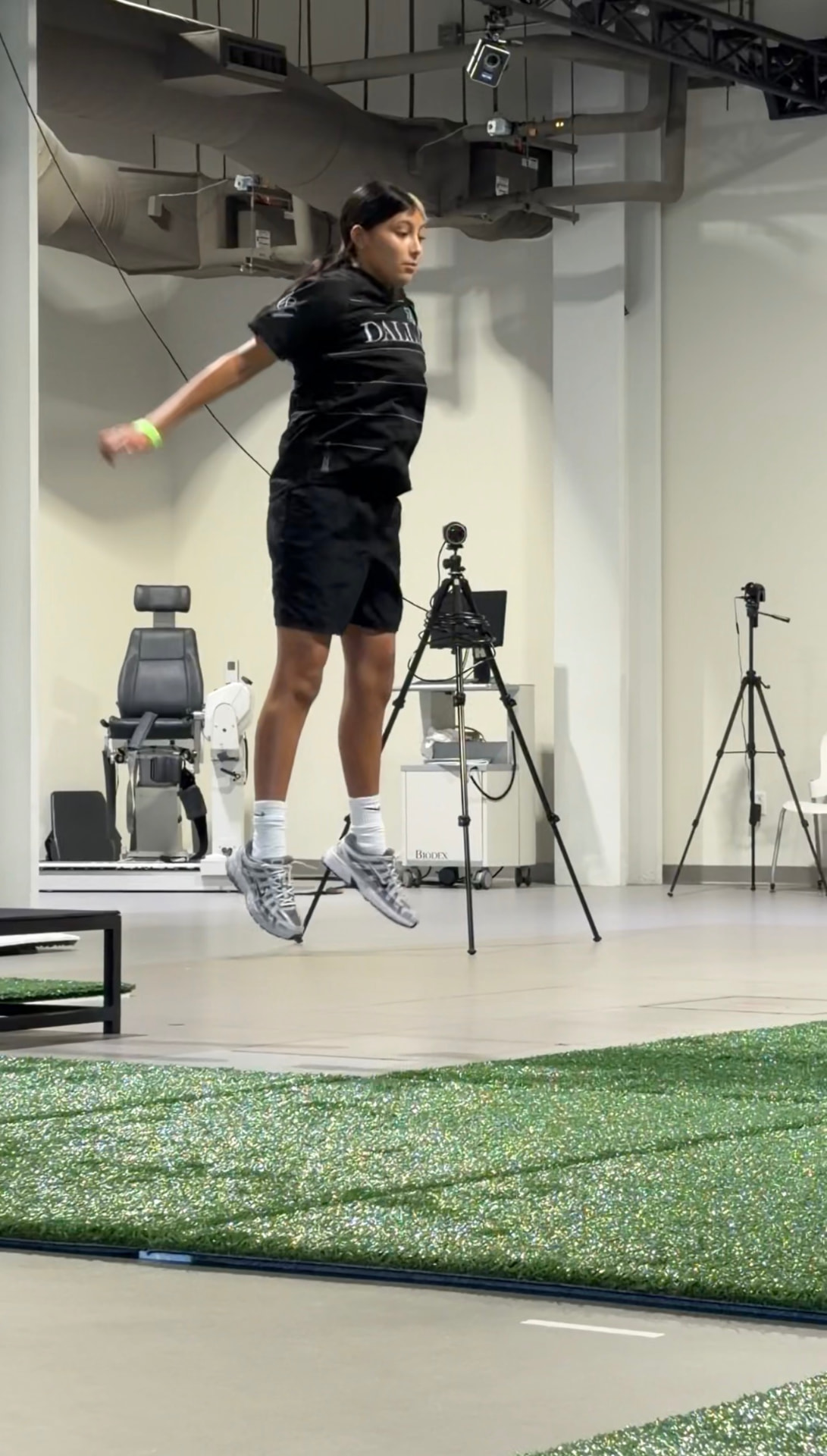 Jaylei performing a vertical jump test in the motion-capture performance lab